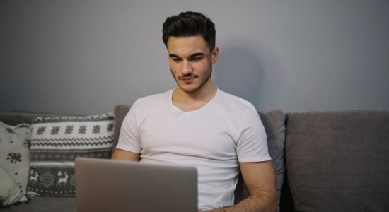 young woman browsing laptop sofa 23 2147771033 Lolzteam: Теневая Империя Рунета. Полный Обзор Форума